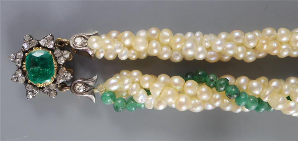 An early 20th century interwoven seed pearl and emerald bead bracelet, with foil backed emerald and diamond cluster set gold clasp,